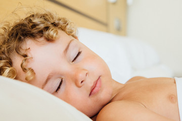 Fototapeta na wymiar Lovely kid sleeping on bed
