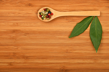 Bay leaves and peppercorn on wood