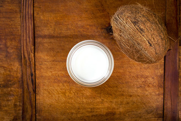 Coconut milk and coconut on a wooden table