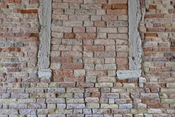 A wall of brick and stone without mortar.
