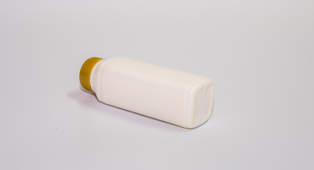 milk in plastic bottle with closed cap on white background