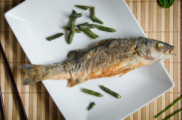 baked sea bass rectangular white plate