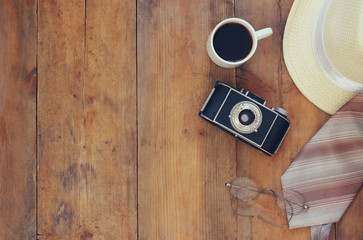 Vintage camera, glasses, cup of coffee and fedora hat