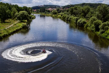 Fototapeten Jet ski turns with much splashes on the river. © notistia