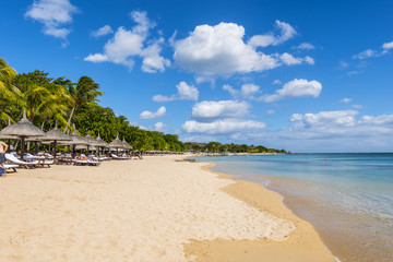Mauritius beach umbrellas, thatch. Tropical Mauritius island water & beach resort, Turtle Bay -...