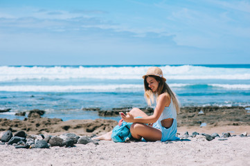 beautiful girl on the beach photographing themselves using mobil
