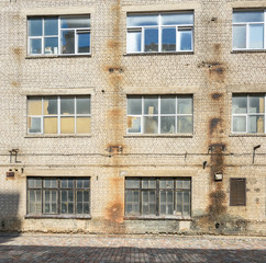 Industrial background, empty grunge urban street with brick wall