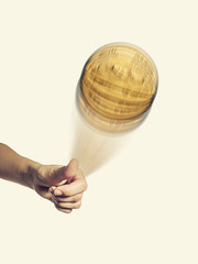 Person hand throwing up a coin to make a decision isolated on toned background