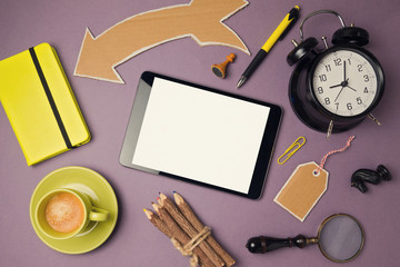 Tablet mock up template with coffee cup, alarm clock and creative objects. View from above. Flat lay