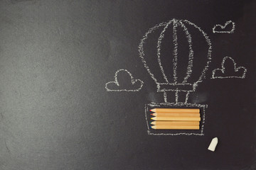 Back to school background with air balloon made from pencils on black board