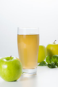 Fresh apples and glass of apple juice.