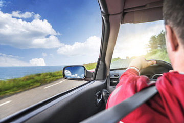 Hands on wheel of a car.