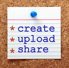 The phrase Create, Upload and Share in blue text on a note card pinned to a cork notice board as a reminder of your content marketing strategy