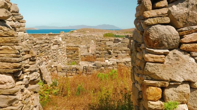 A crane shot featuring ancient house ruins in the Greek island of Delos
