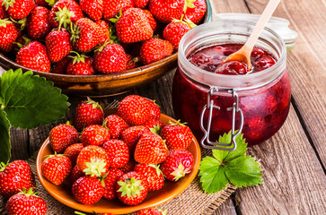 Strawberry on wood background. Strawberry with green leaves.