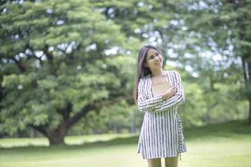 Attractive woman reading a book in the park