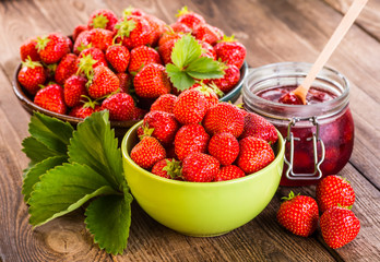 Strawberry on wood background. Strawberry with green leaves.