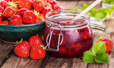 Strawberry on wood background. Strawberry with green leaves.