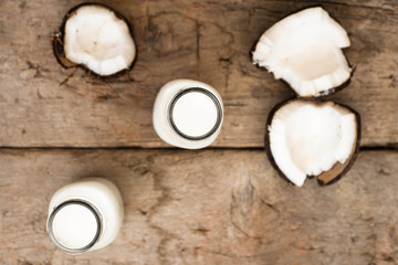 Obraz na płótnie Canvas Coconut milk on wooden table Eye bird view