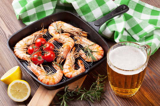 Grilled shrimps on frying pan and beer