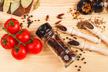 Different spices and branch of cherry tomatoes