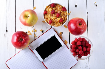 Healthy food concept: cereal berries and apple on a wooden table