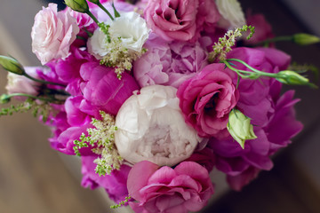 Rich bunch of pink peonies and lilac eustoma roses flowers