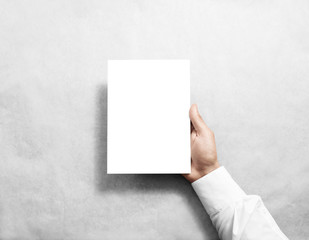 Hand holding blank white brochure booklet in the hand. Leaflet presentation. Pamphlet hold hand....