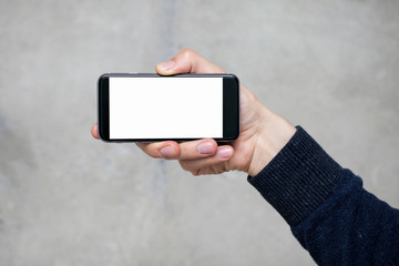 man holding a phone with isolated screen over the desk in the of