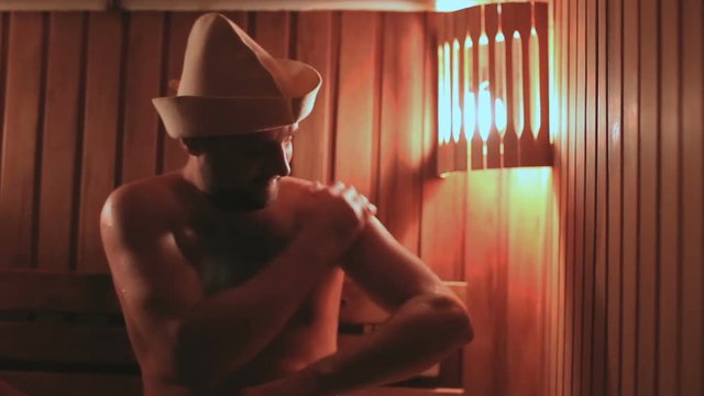 strong caucasian man relaxing in sauna spa