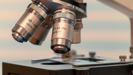 Microscope and test tubes in laboratory, Blue toned image