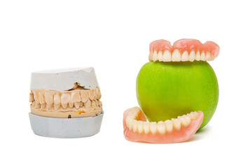 Cast and dentures with green apple