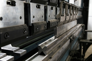 operator bending metal sheet by sheet bending machine