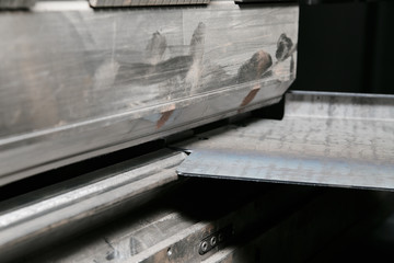 operator bending metal sheet by sheet bending machine