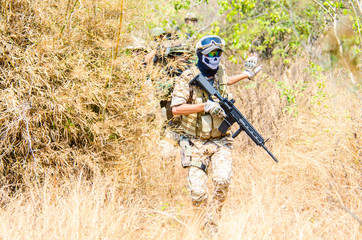 Portrait of men in action Airsoft gun.