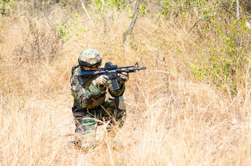 Portrait of men in action Airsoft gun.