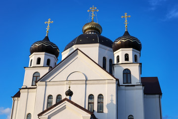 Fototapeta premium Orthodox Church with domes against the blue sky