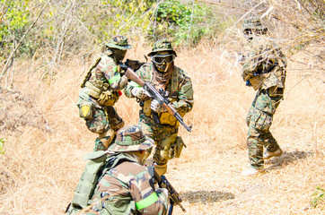 Portrait of men in action Airsoft gun.