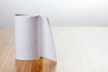 roll of paper towels on the glossy wooden kitchen table