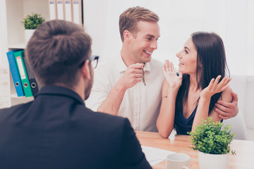 Portrait of happy family holding keys from new house