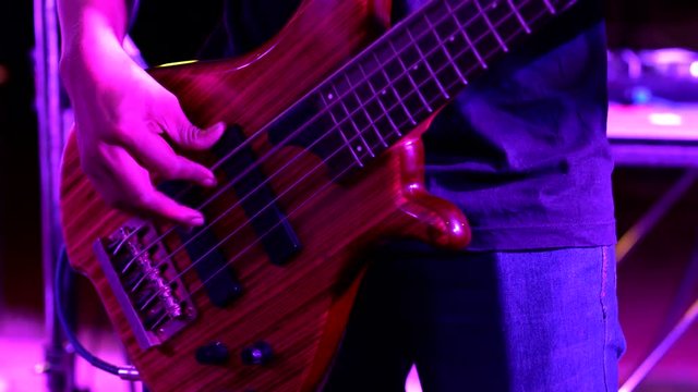 4K music footage ; Hands of a teenager plays guitar bass - Guy who playing on electric guitar
