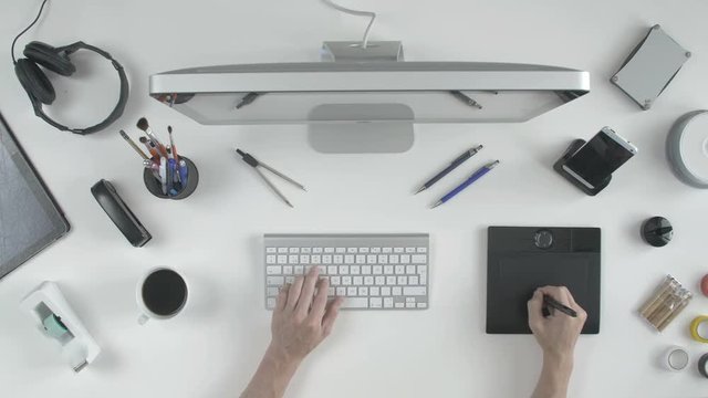 top view man architect 3D designer uses his pen tablet with his computer