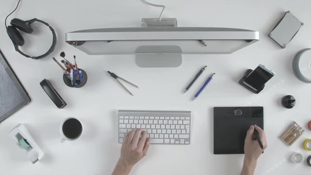 top view man architect 3D designer uses his pen tablet with his computer