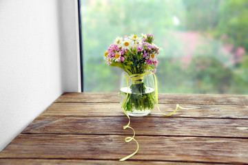 Beautiful meadow flowers bouquet in room © Africa Studio
