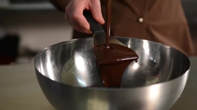 versare del cioccolato fondete in un contenitore