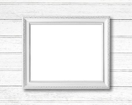 White blank picture frame on wood wall.