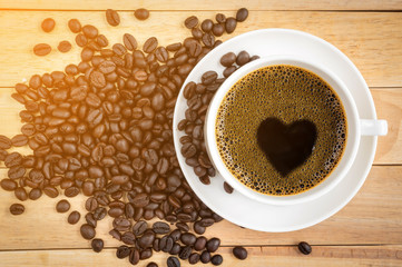 Cup of coffee on wood background.