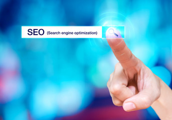 Finger touch on search button with search bar and SEO (Search en