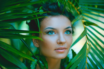 sensual portrait of young beautiful woman with jungle background