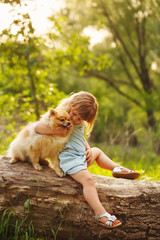 Little girl kisses Spitz